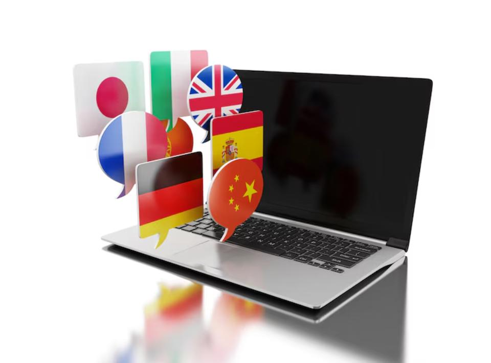  A laptop with various speech bubbles displaying international flags, representing diverse languages and global communication.