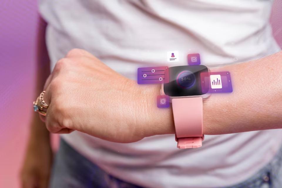 A close-up of a woman's wrist wearing a pink smartwatch, displaying health metrics and app icons in a vibrant, digital overlay.