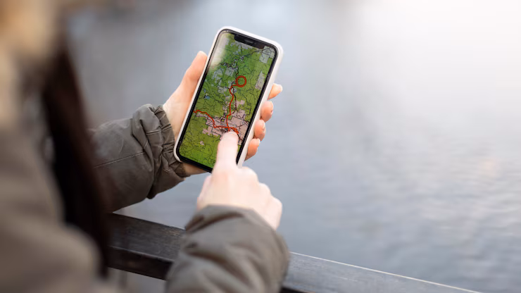 hand on a smartphone in which maps app is opened
