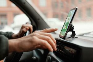 person using GPS in car